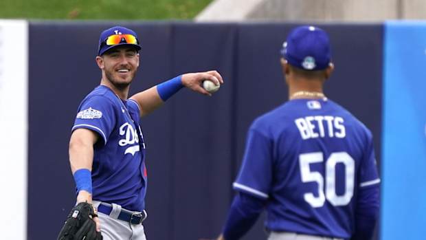 Feb 28, 2020; Phoenix, Arizona, USA; Los Angeles Dodgers center fielder Cody Bellinger (35) and Mookie Betts (50) warm up in between innings against the Milwaukee Brewers during a spring training game at American Family Fields of Phoenix. Mandatory Credit: Rick Scuteri-USA TODAY Sports